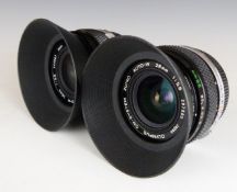 Two Olympus OM-system Zuiko Auto-W 28mm 1:2.8 camera lenses