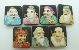 Seven Toshikane Japanese porcelain buttons, each depicting a different god of fortune