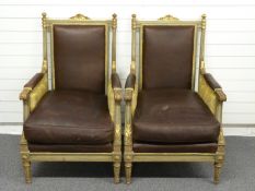 A pair of upholstered continental style giltwood armchairs with faux leather cushions raised on