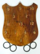 A vintage wooden hoopla or quoits game with shield shaped back and rubber hoops.