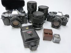 Two Olympus OM10 SLR cameras with f=50mm 1:1.4, f=50mm 1:1.8, and 35-70mm 1:4 lenses together with
