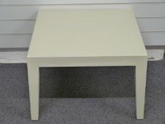 A designer square coffee table raised on tapering legs, probably Philippe Hurel, Paris, W 60 x D