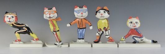 Five Lorna Bailey cat figures comprising Skiing, Snowboarding, Ice Skating/Hockey and Curling,