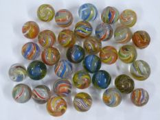 Thirty-three glass marbles with multi-coloured and latticinio twists, each approximately 18mm in