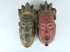 A pair of African Ivory Coast tribal Baule carved male and female masks purchased by the vendor in