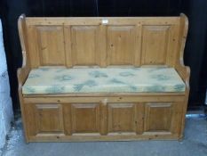 Pine panelled settle with lift up seat, L119cm