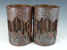 A pair of 19th/20thC carved bamboo brush pots decorated with court scenes, H18cm
