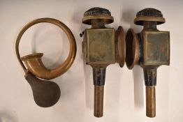 Two carriage lamps, one marked Limehouse Lamp Co, height 41cm, and a brass bulb horn