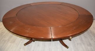 A circular mahogany dining table with outer extensions, diameter 152, fully extended 212cm