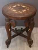 Eastern carved occasional table with elephant supports, D56 x H60cm