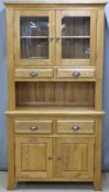 A contemporary light oak glazed dresser, W100 x D43 x H192cm
