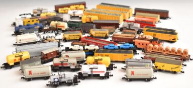 Fifty-nine Graham Farish, Lima or similar N gauge model railway goods wagons, brake vans etc