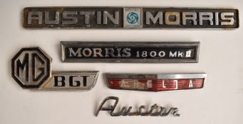 Five motor car badges comprising Austin, MG BGT, Anglia, Austin Morris and Morris 1800 MKII