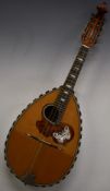 Unlabelled late 19thC semi flat backed mandolin, the tortoiseshell pick guard inlaid with mother-