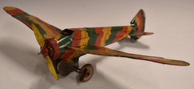 Mettoy tinplate clockwork model aeroplane with sparking cockpit gun and folding wings.