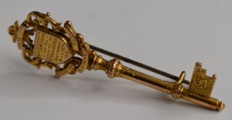 A 9ct gold presentation brooch in the form of a key with inscription 'Presented to Mrs D W Evans