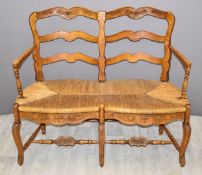19thC carved oak Arts and Crafts style rush seated sofa, W111 x D54 x H95cm