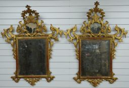 A pair of 18thC Italian Rococo giltwood framed mirrors with silvered glass and arching finials, W100