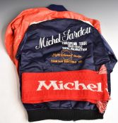 Two Michel Sardou concert jackets, one a navy and red waterproof hooded example, the other a satin
