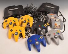 Two Nintendo 64 video games consoles with six controllers and six games including Goldeneye, Pokemon