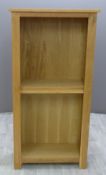 A contemporary light oak bookcase, W75 x D35 x H151cm