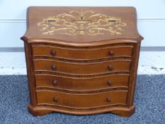 A mahogany serpentine fronted apprentice chest of four graduated drawers with rosewood columns,