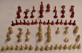 A carved bone chess set with on side stained red together with a very similar part set, height of