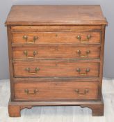 A mahogany bachelor's chest of four graduated drawers with brush slide, raised on bracket feet,