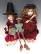 Two vintage bisque headed dolls together with a peg jointed wooden doll with glass bead eyes.
