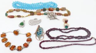 A collection of costume jewellery including garnet necklace, silver ring, agate necklace, pressed