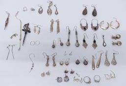 A collection of silver earrings, rings and brooches