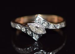 A 9ct gold ring set with a marquise cut diamond and further diamonds to the shoulders, 1.9g, size I