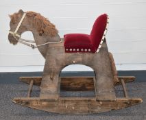 Wooden rocking horse with upholstered seat and wool mane and tail, length 91cm