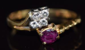 An 18ct gold ring set with an oval cut ruby and four diamonds, 2.9g, size N