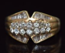 A 14k gold ring set with round and baguette cut diamonds, 6g, size O