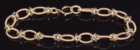 A 9ct gold bracelet made up of engraved oval links, 12.2g