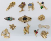 A collection of designer brooches including Monet, Piadoro, etc