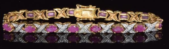 A 9ct gold bracelet set with oval cut rubies and diamonds, 13.7g