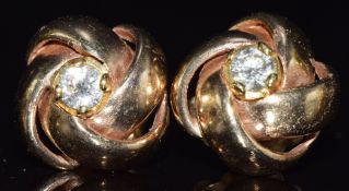 A pair of 9ct gold knot earrings set with a round cut diamond of approximately 0.2ct to each, 8.6g