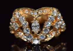 An 18ct gold ring set with a marquise cut diamond and round cut diamonds, size M, 10g