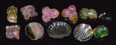 A loose emerald cut watermelon tourmaline, carved sections of watermelon tourmaline and three carved