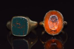 A 9ct gold ring set with paste (5.4g, size F) and a ring marked 333 set with bloodstone (4.9g)