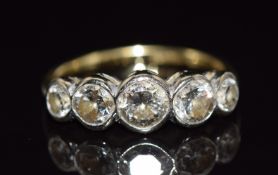 An 18ct gold ring set with five old cut diamonds measuring approximately 0.5, 0.35, 0.35, 0.14 & 0.