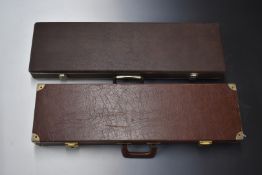 Two vintage gun cases, both with leather style finish and fitted interiors, largest 82x24x8cm.