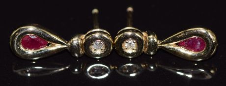 A pair of yellow metal earrings set with a pear cut ruby and diamond to each, 1.8g, 1.5cm