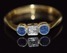 An 18ct gold ring set with a diamond and sapphires, 2.2g, size K