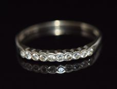 An 18ct gold half eternity ring set with nine diamonds, 1.3g, size P