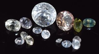 A round cut white sapphire, a round cut orange/ pink sapphire, a pale pink sapphire and 13 white and