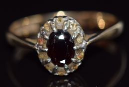 A 9ct gold ring set with a garnet and paste, 3.8g, size U
