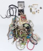 A collection of costume jewellery including beads, brooches, necklaces including Navajo, silver